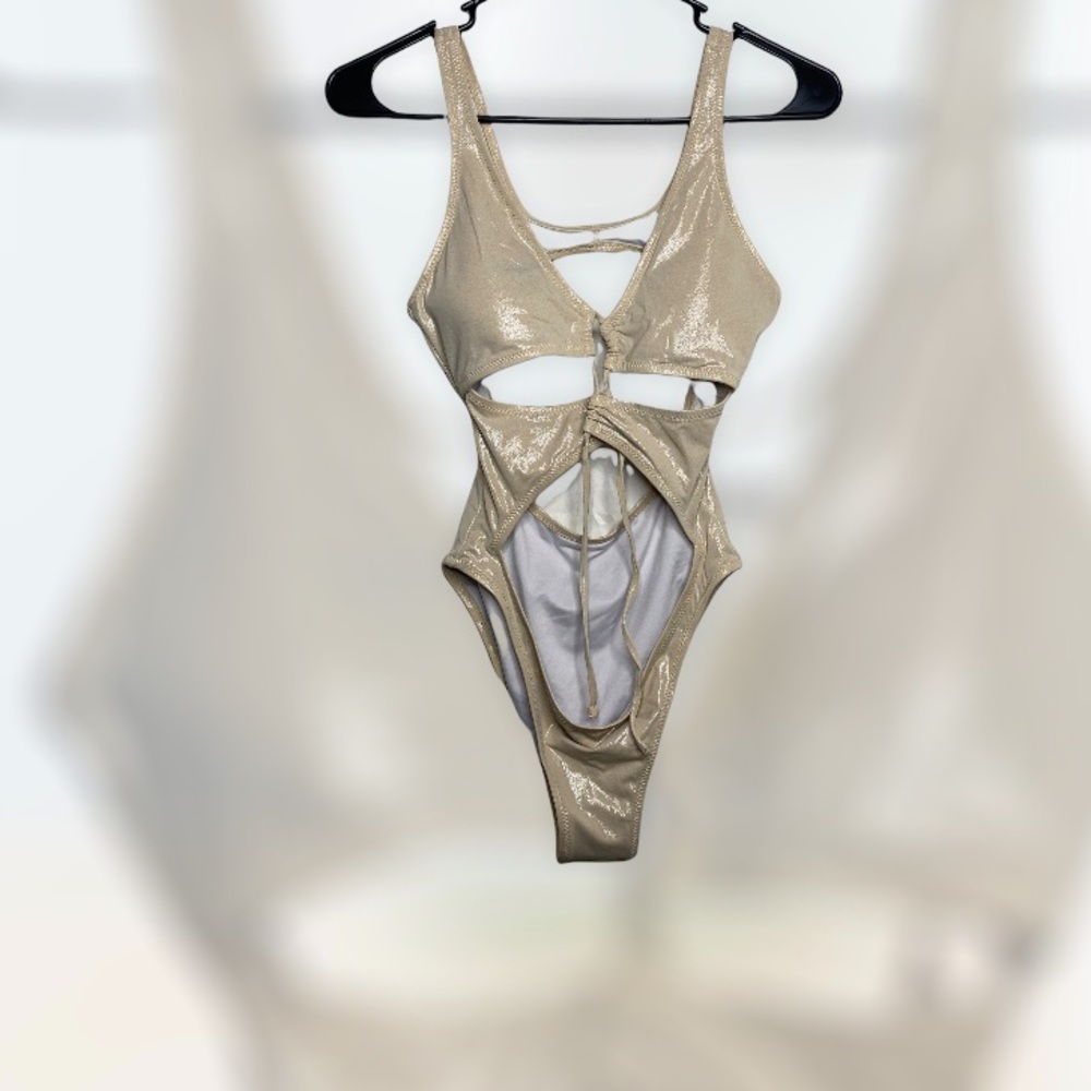 Fashion Nova nude body suit. One piece with cut out designs.